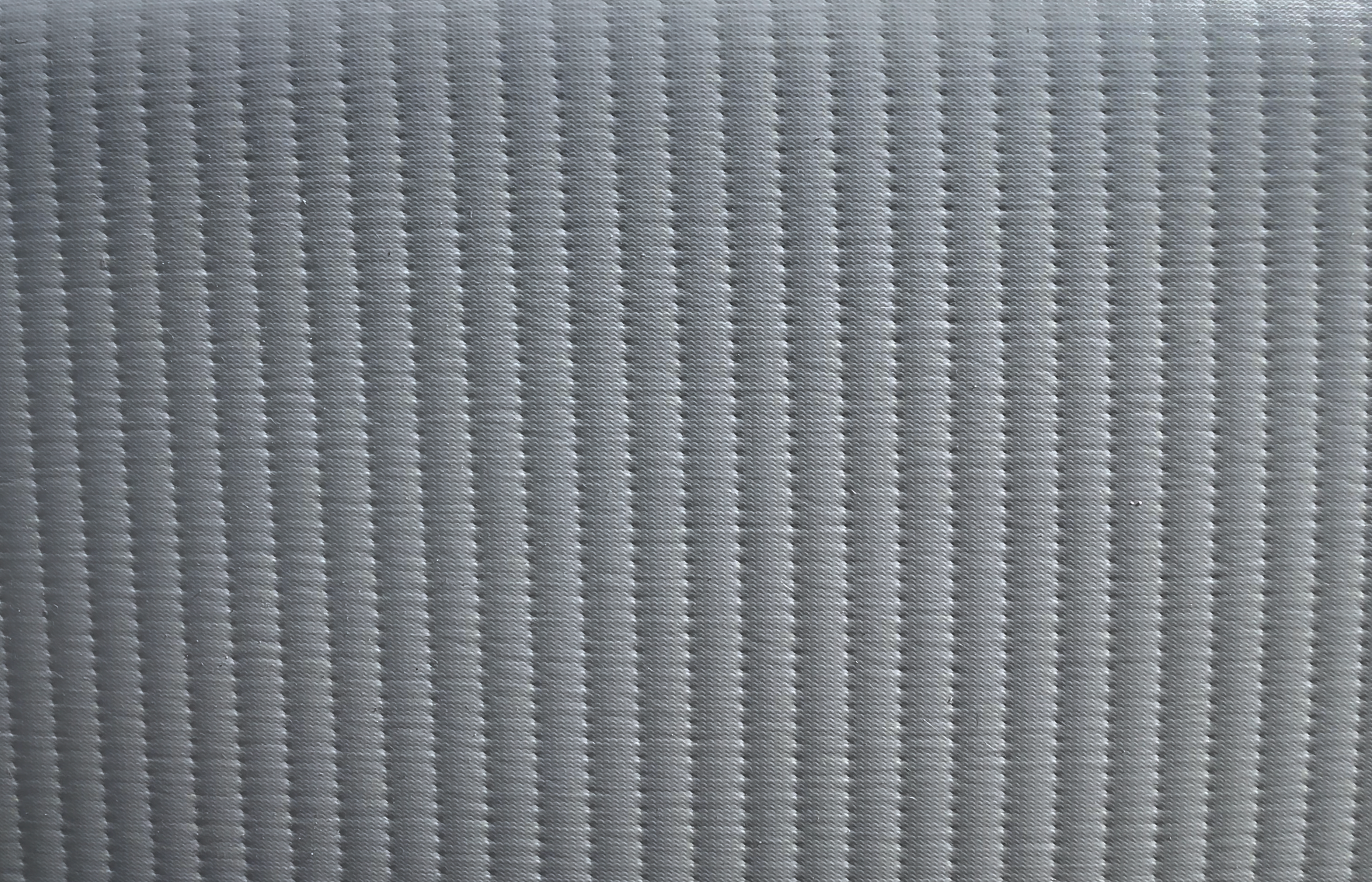 Close‑up texture of Perfect Pool’s drop‑stitch rigid‑wall material showing the energy‑efficient insulation pattern that retains warm water